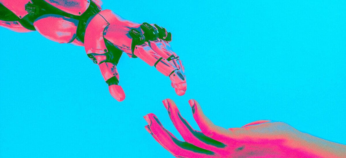 Pink and blue robot hand reaching out to a human hand