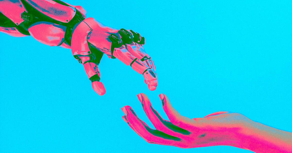 Pink and blue robot hand reaching out to a human hand